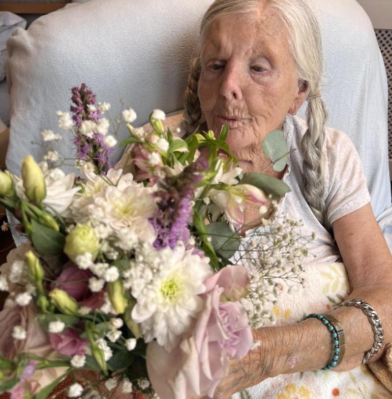 Madge enjoying her flowers