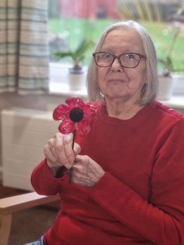 Cherry Blossom resident with the poppy she made for Remembrance Day