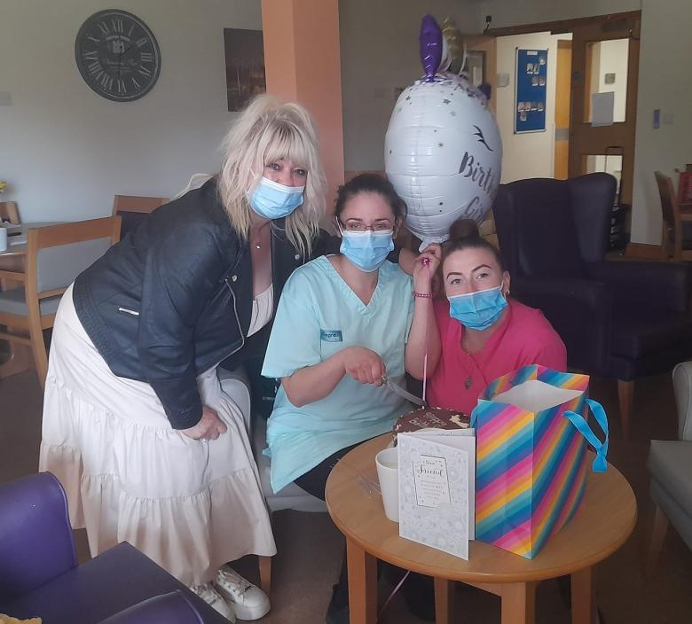 care home staff celebrating activities coordinator's birthday