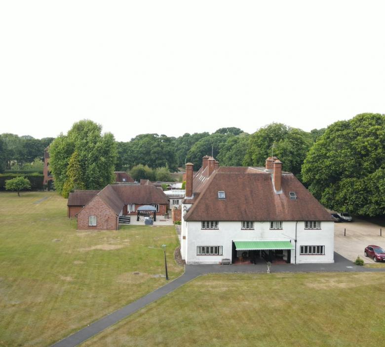 drone shot of New Forest Nursing Home with trees surrounding it
