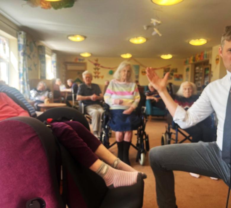 Mike Siddaway singing to a resident at Fordingbridge