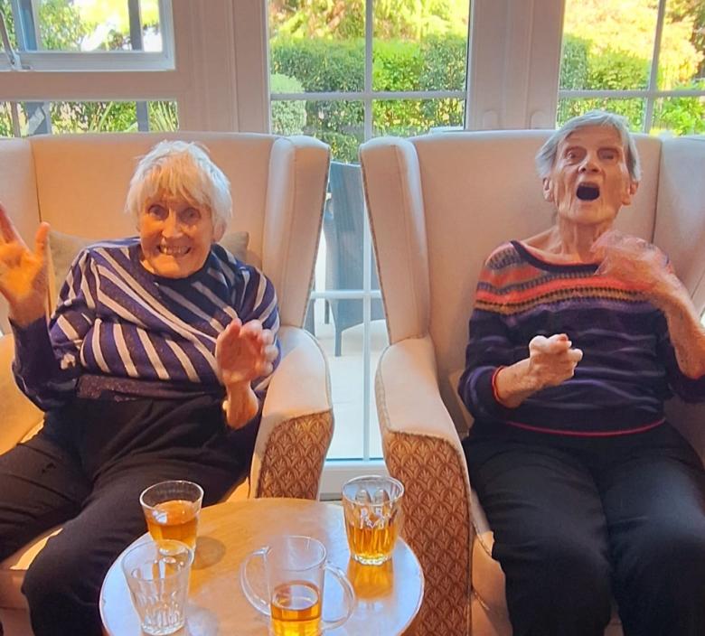 2 Fairmile Grange residents enjoying Sandra's piano playing