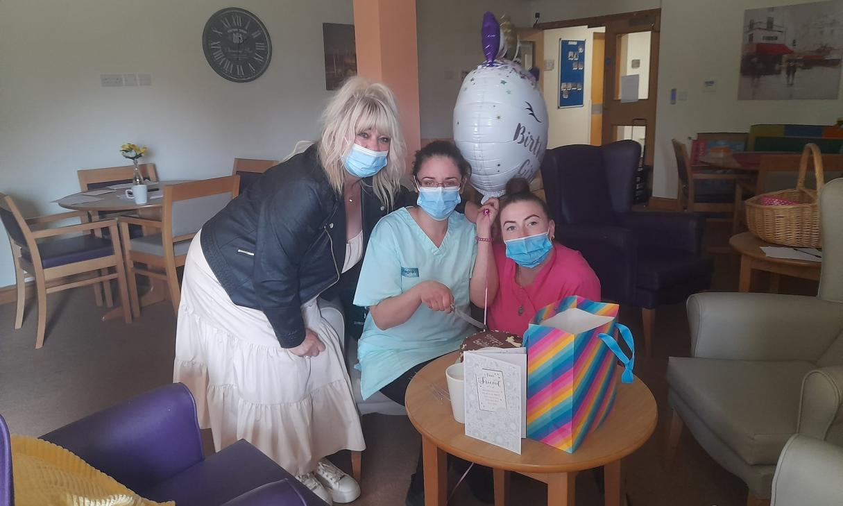 care home staff celebrating activities coordinator's birthday