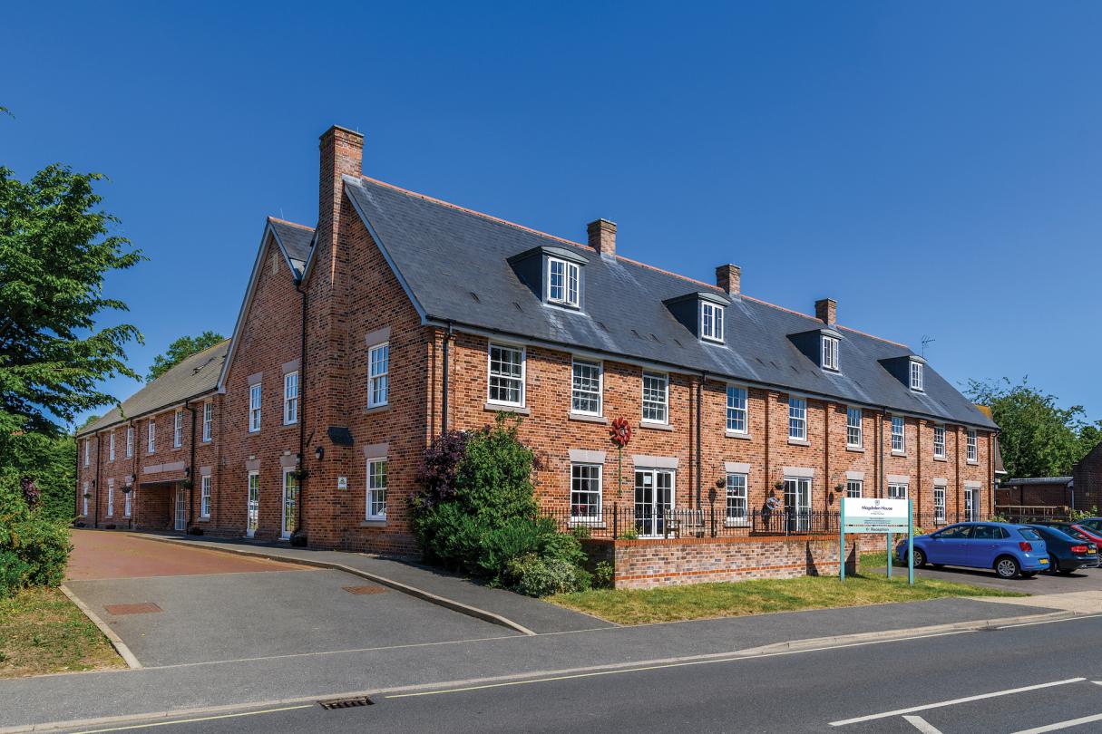 exterior of Magdalen House Care Home against blue skies