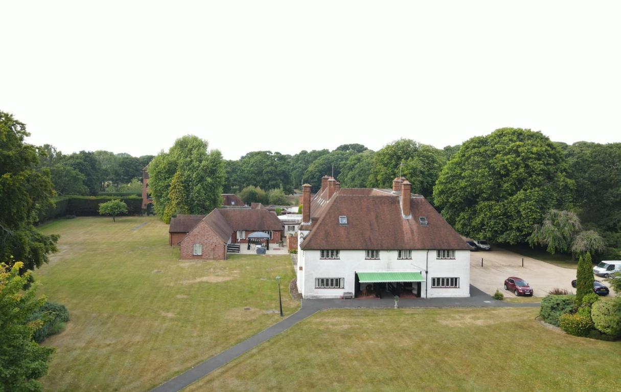 drone shot of New Forest Nursing Home with trees surrounding it
