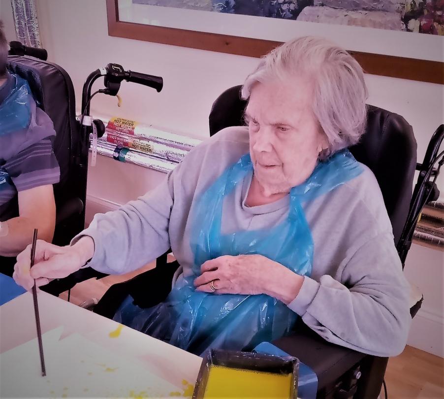 Residents at Cedar Lawn straw painting 