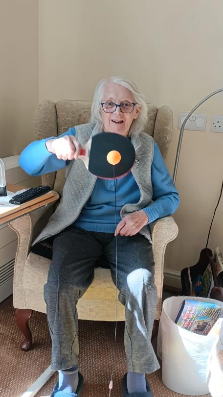 one of the magdalen care home residents playing ping pong