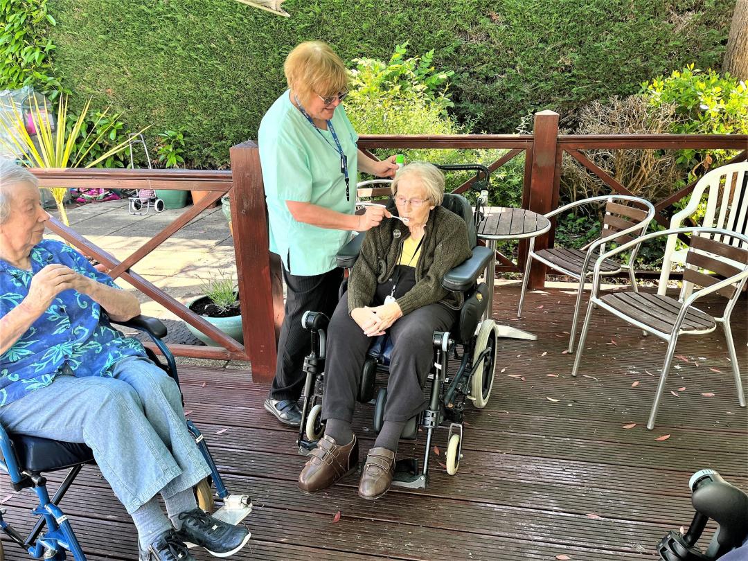 Residents at Allegra Care's Cedar Lawn care home blowing bubbles