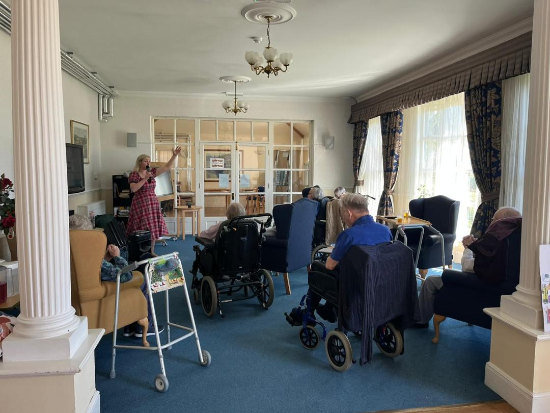 Alice applewood singing to residents at Cedar Lawn 