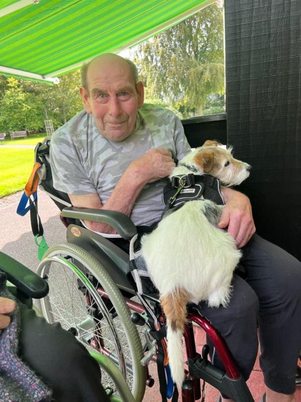 Derek holding a doggy visitor