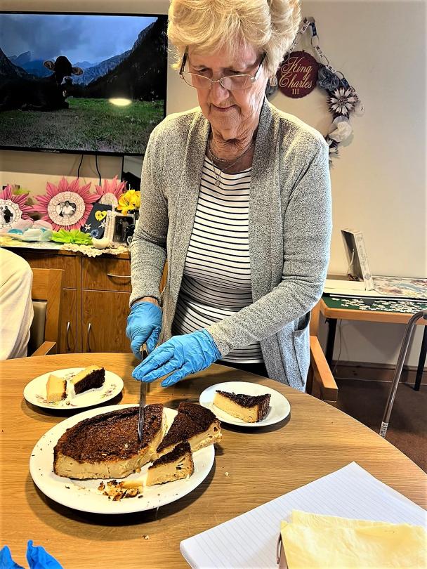 Shirley serving up the delicious cake made by Cherry Blossom residents today,