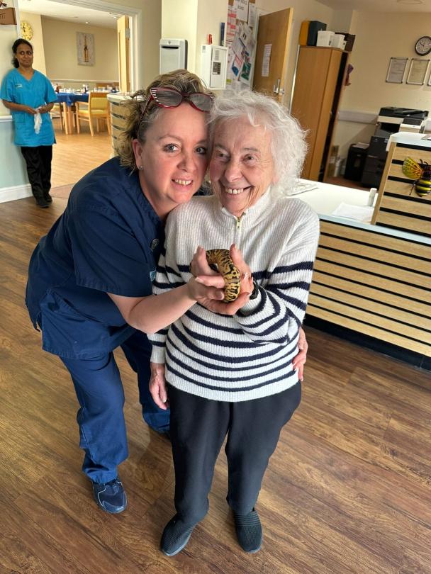 resident holding Queen Camilla the Royal Python