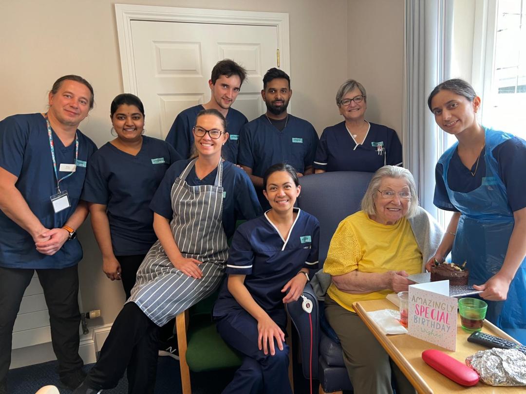 Staff helping Eileen celebrate her birthday