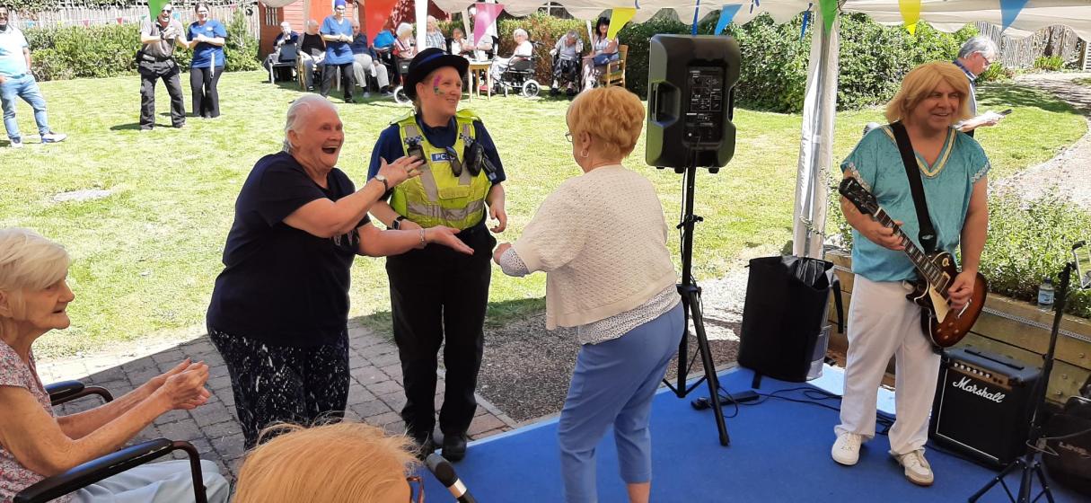 Residents dancing with Martha from Peterborough Police