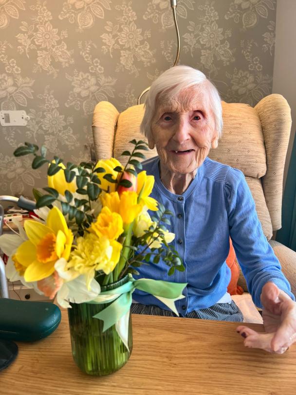 Fairmile Grange Resident enjoying her flowers
