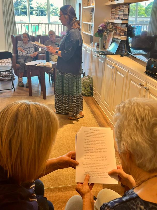 Reverend Kay performing a service for residents