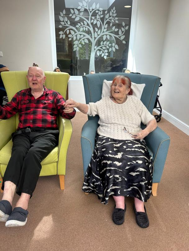 residents enjoying listening to Hannah play the saxophone