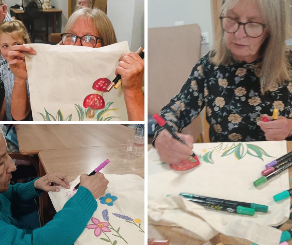Residents painting tote bags