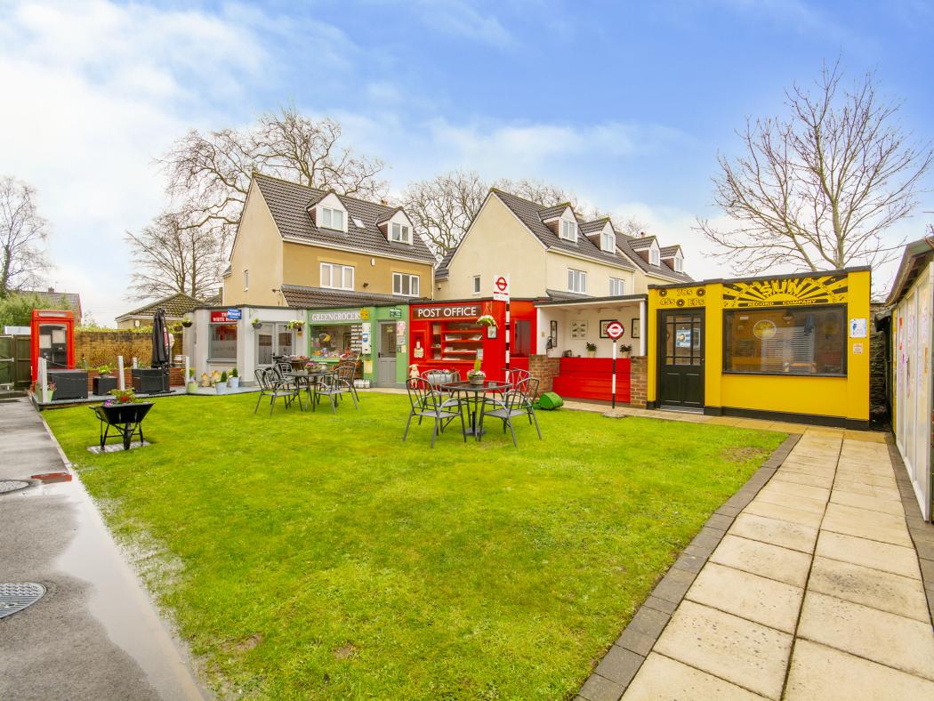 Community area at Blossom Fields, with small shops and outdoor seating