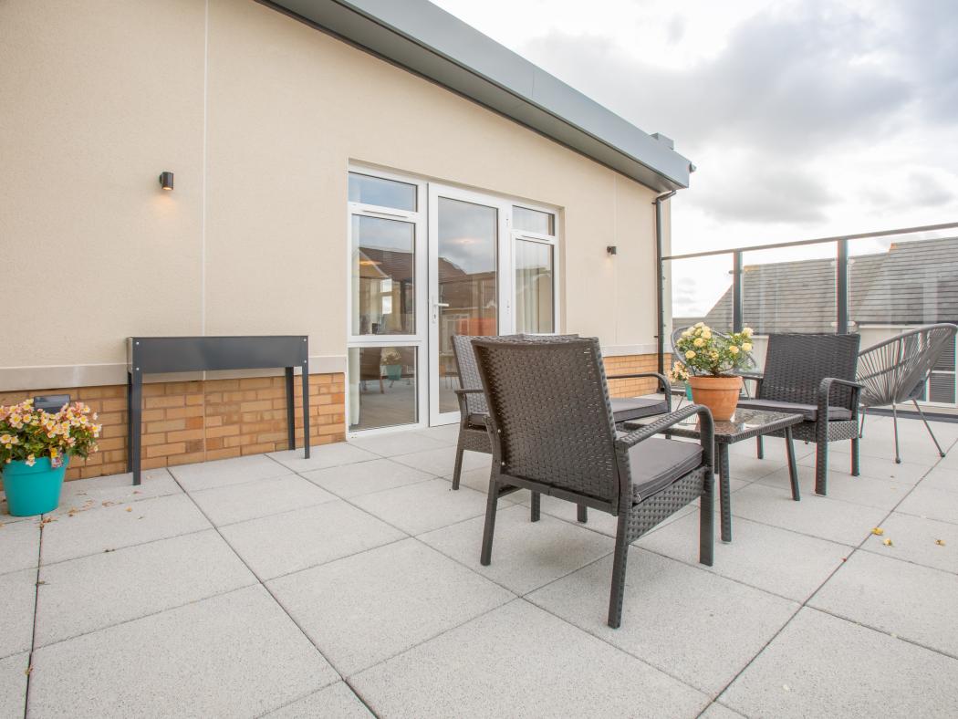 Outdoor terrace at Rose Garden Care Home, with a seating area perfect for enjoying fresh air