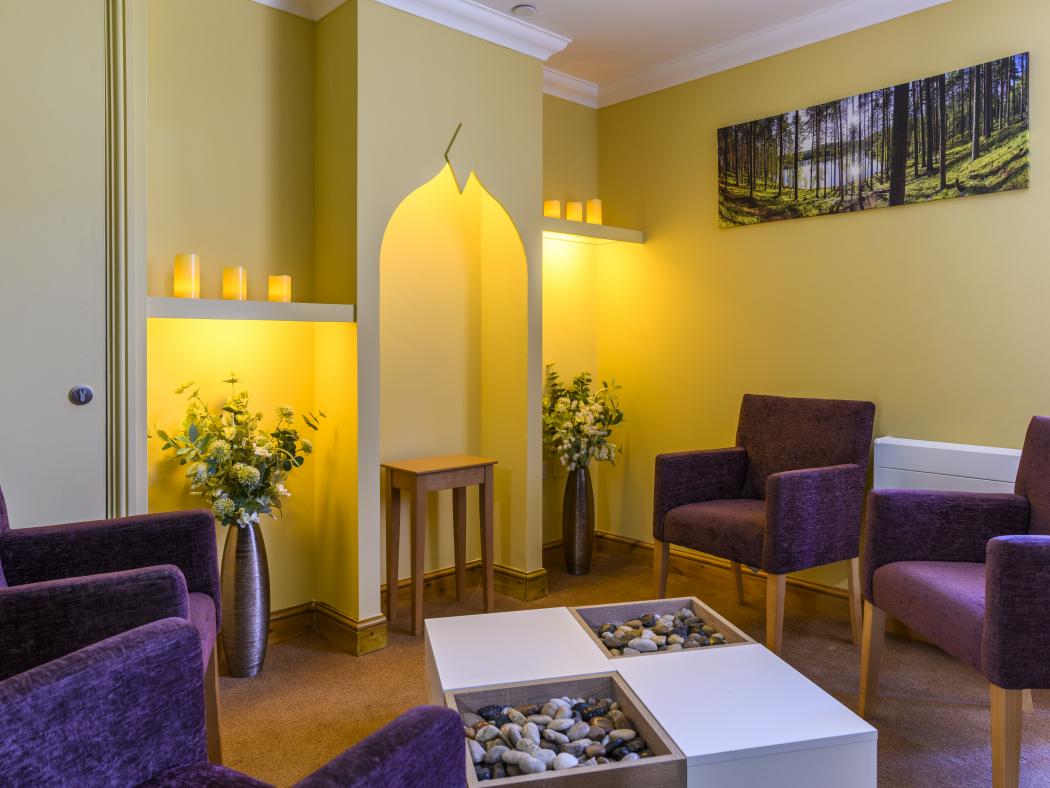 care home tranquil room with purple armchairs and candles lit