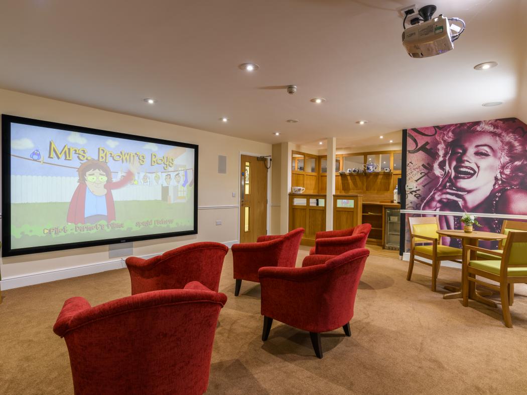 care home living room with large projector screen 
