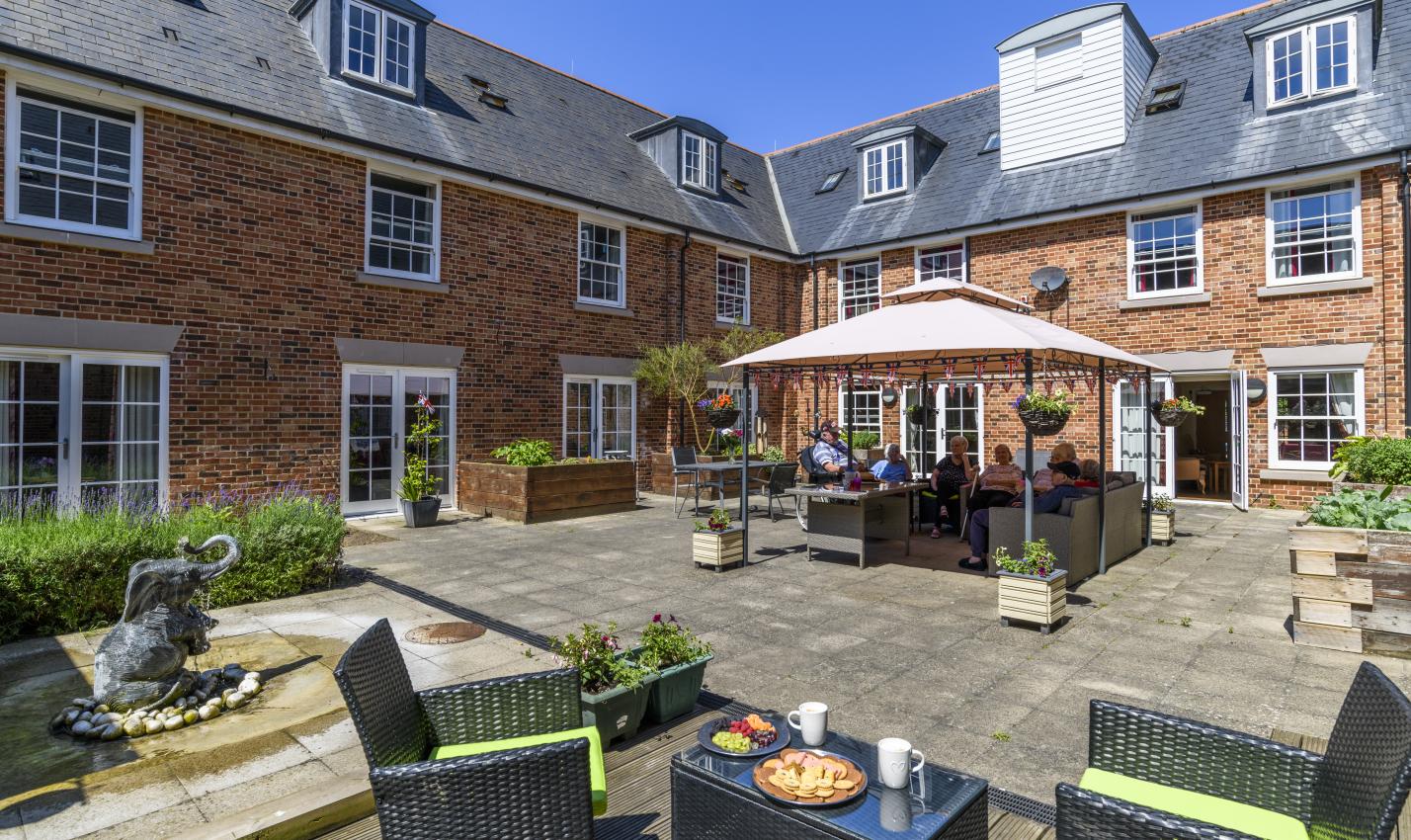 Magdalen House Care Home residents sitting in the courtyard