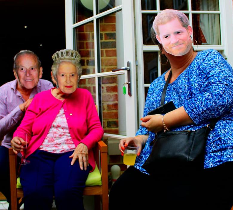 care home residents wearing masks of royal family