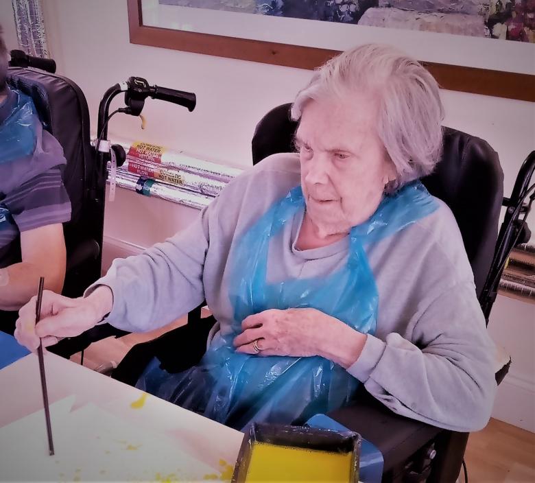 Residents at Cedar Lawn straw painting 