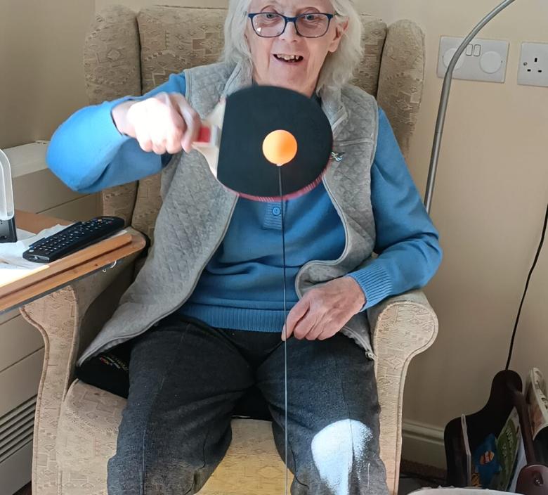 one of the magdalen care home residents playing ping pong