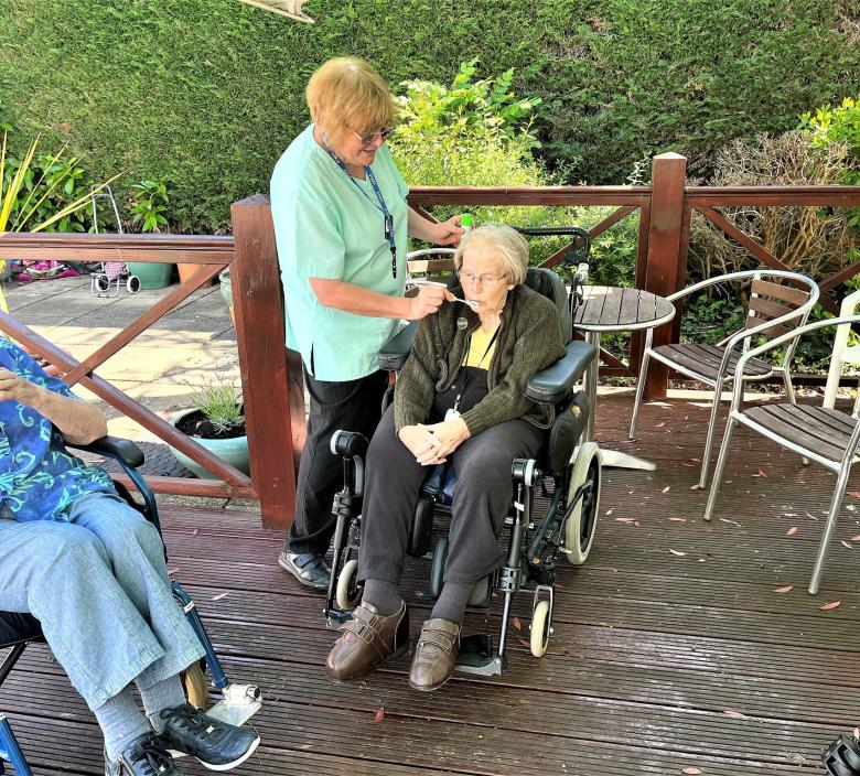Residents at Allegra Care's Cedar Lawn care home blowing bubbles