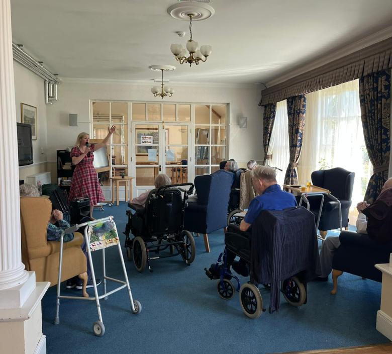 Alice applewood singing to residents at Cedar Lawn 