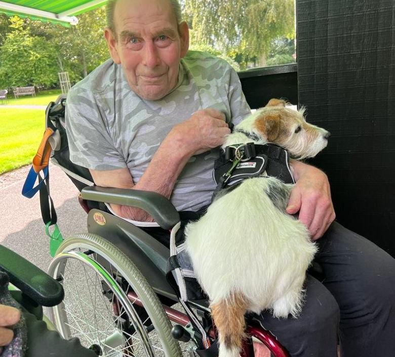 Derek holding a doggy visitor