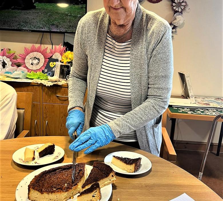 Shirley serving up the delicious cake made by Cherry Blossom residents today,