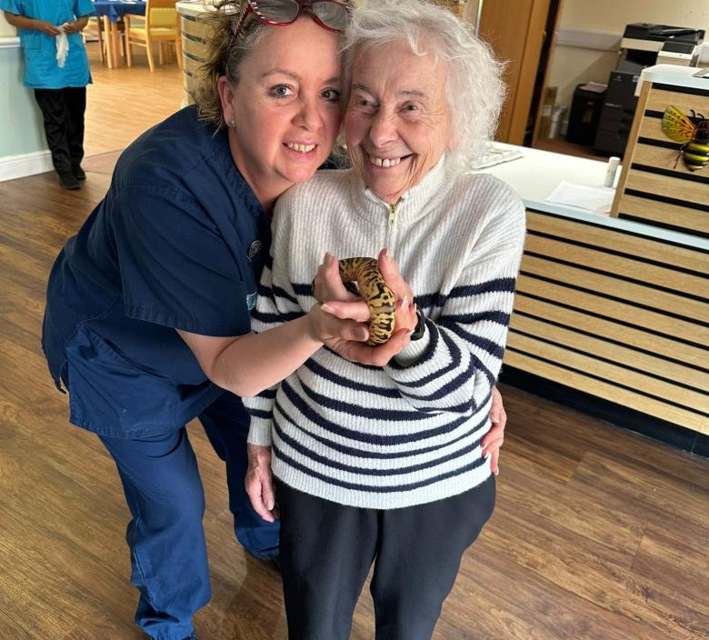 resident holding Queen Camilla the Royal Python