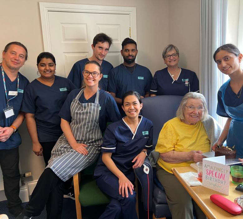 Staff helping Eileen celebrate her birthday
