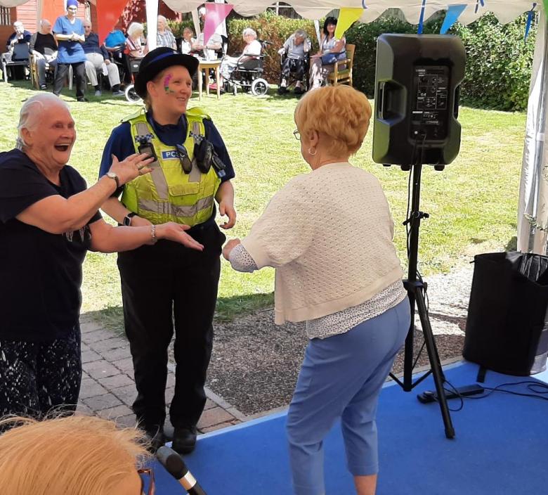 Residents dancing with Martha from Peterborough Police