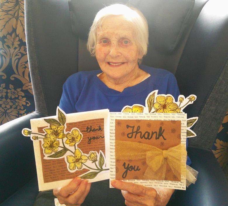 Cedar Lawn Resident showing her craft work for the local GP