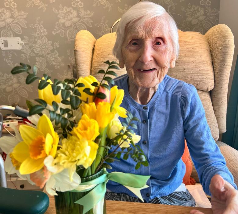 Fairmile Grange Resident enjoying her flowers