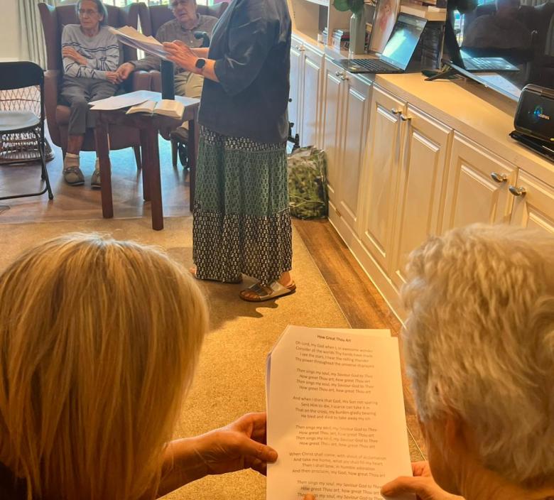 Reverend Kay performing a service for residents