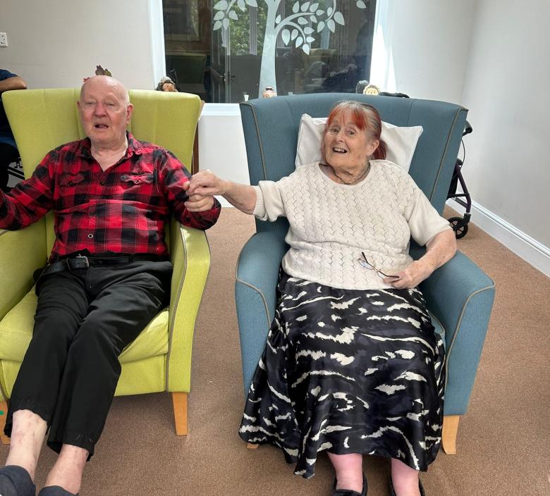 residents enjoying listening to Hannah play the saxophone