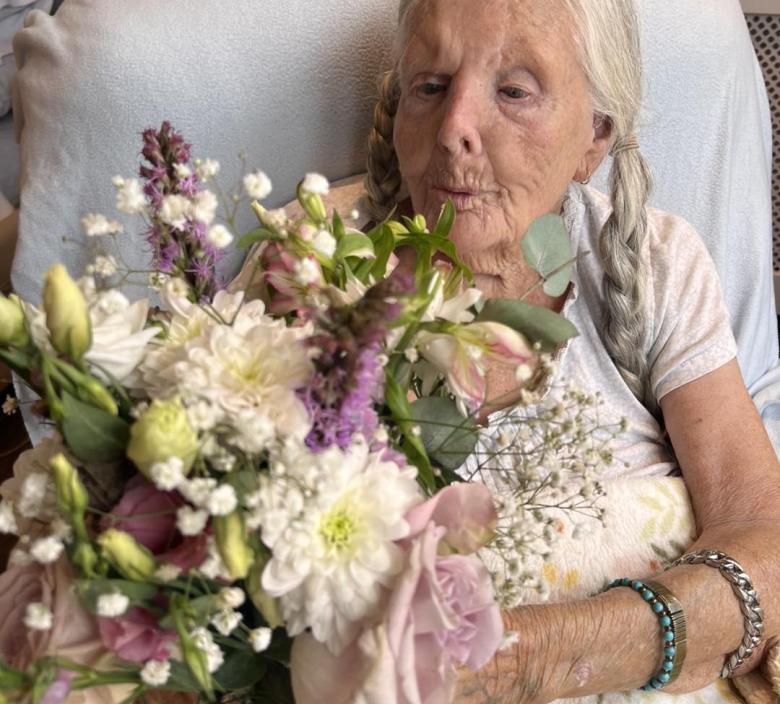 Madge enjoying her flowers