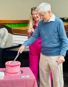 Resident cutting cake at st georges